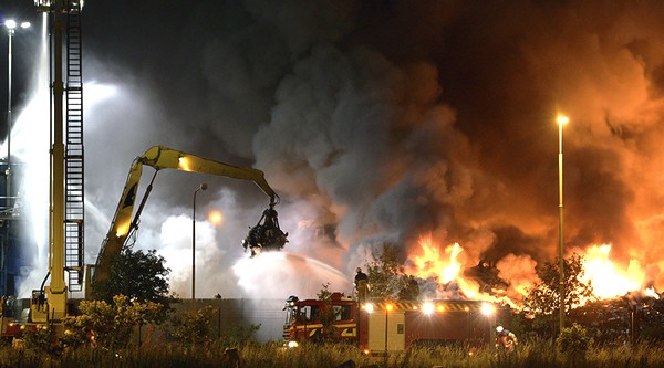 Firefighters work to extinguish flames after a massive blaze torched a recycling station in Malmo